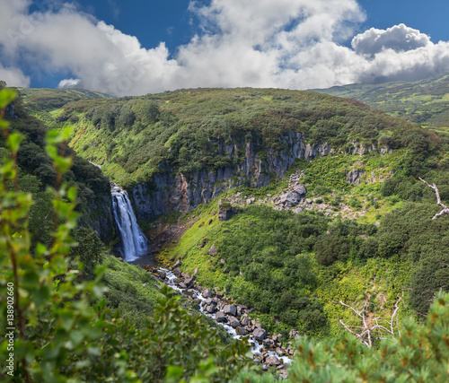 Waterfall Spokoyny in brookvalley at the foot of outer north-eastern slope of caldera volcano Gorely.