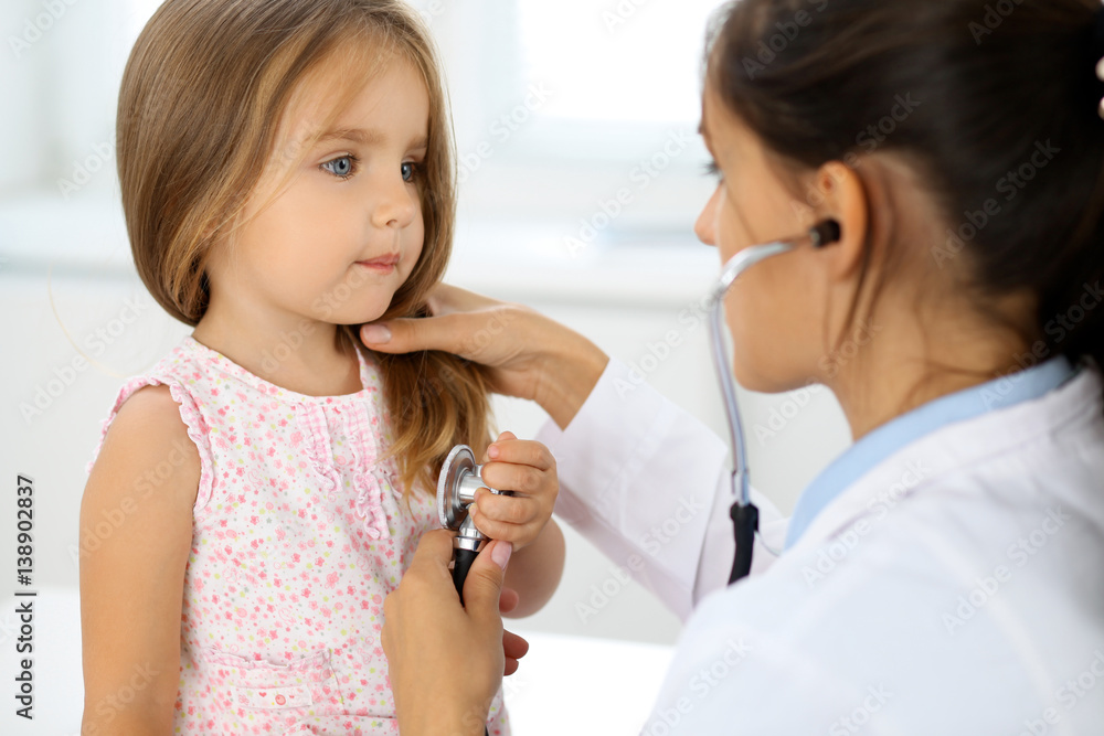 Doctor examining a little girl by stethoscope Doctor examining a little girl by stethoscope