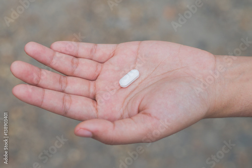 Medicine pills or capsules in hand, Medicine in palm © Bankerd