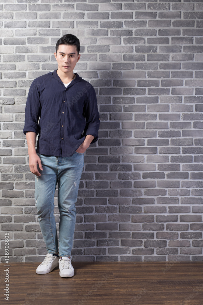 man stand with brick wall man stand with brick wall