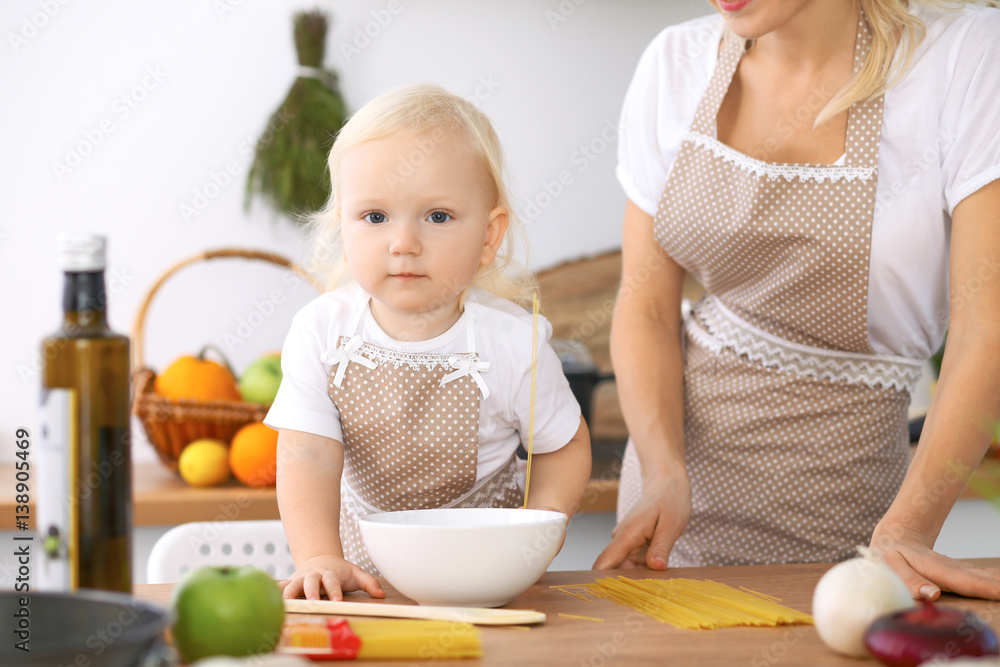 Happy family in the kitchen. Mother and child daughter cooking tasty breakfest Happy family in the kitchen. Mother and child daughter cooking tasty breakfest