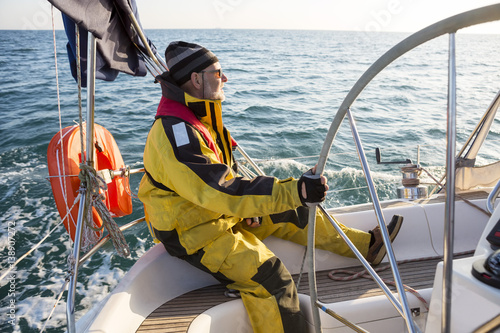 Mature Man Wearing Wind Jacket On Sailing Boat