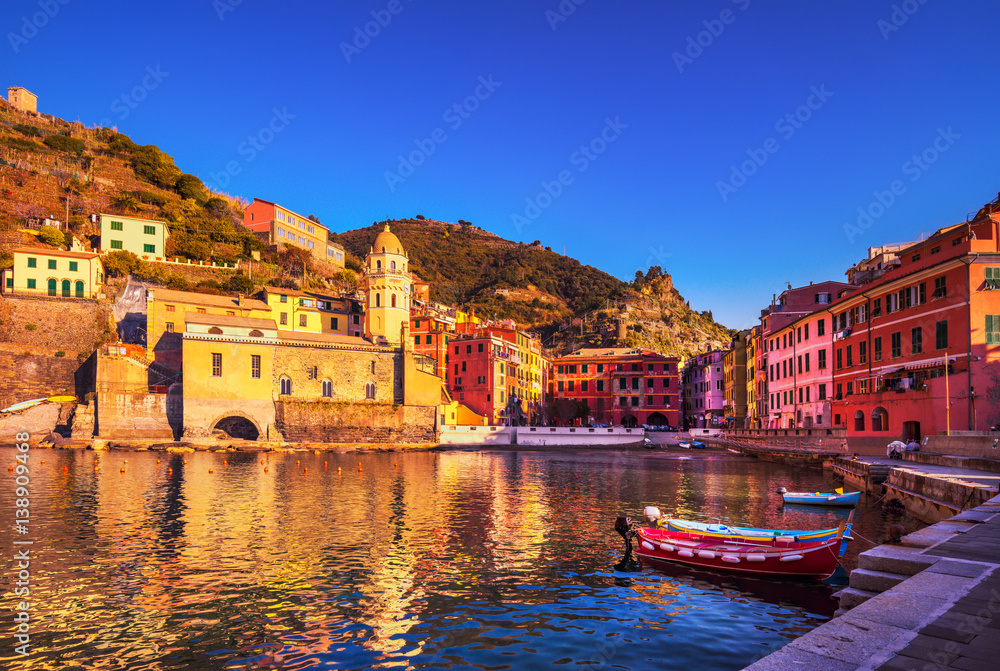 Vernazza village, church, boats and sea harbor on sunset. Cinque Terre, Ligury, Italy