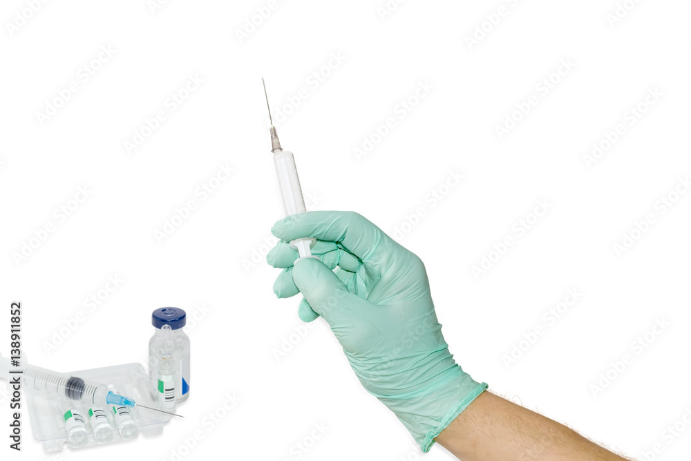 Medical syringe in a male hand wearing a medical glove Medical syringe in a male hand wearing a medical glove