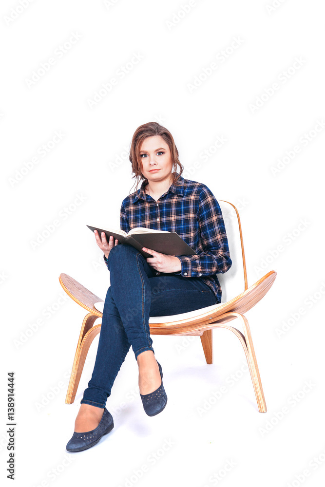 Full length portrait of siting beautiful woman student holding book isolated on a white background Full length portrait of siting beautiful woman student holding book isolated on a white background