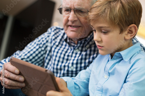 Little Boy and Granddad Playing on Tablet Computer