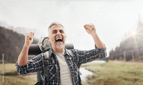 Fotografía Cheerful hiker celebrating with raised fists