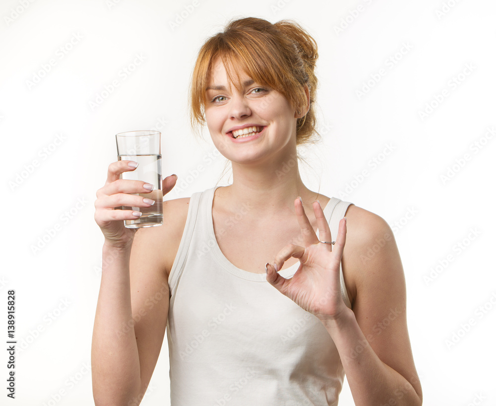 sporty woman over gray background holding glass of water sporty woman over gray background holding glass of water