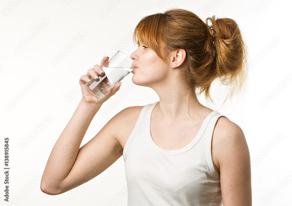 sporty woman over gray background holding glass of water sporty woman over gray background holding glass of water