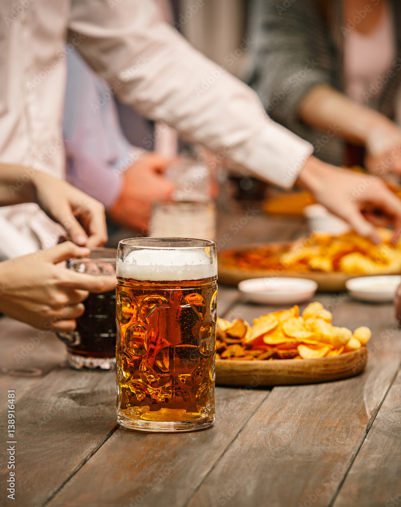 Group of friends enjoying evening drinks with beer Group of friends enjoying evening drinks with beer