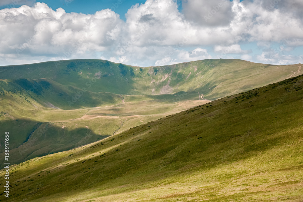 Summer landscape in mountains and the dark blue sky with clouds