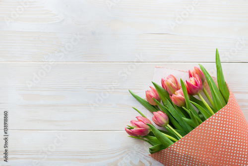 Fototapeta Naklejka Na Ścianę i Meble -  Colorful tulips on wooden table. Top view with copy space
