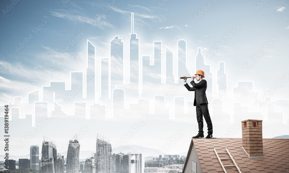 Engineer man standing on roof and looking in spyglass. Mixed med Engineer man standing on roof and looking in spyglass. Mixed med