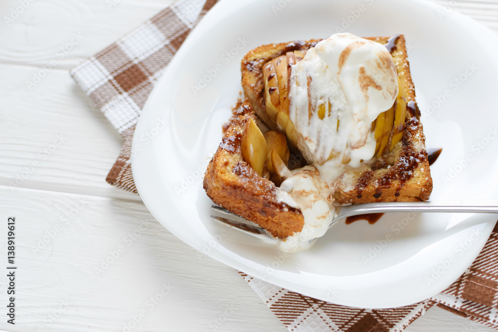 Delicious homemade dessert. Baked toast with apples and ice cream drizzled with chocolate Delicious homemade dessert. Baked toast with apples and ice cream drizzled with chocolate
