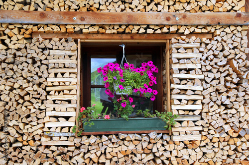 Fototapeta Naklejka Na Ścianę i Meble -  Travel to Sankt-Wolfgang, Austria. The window with the flowers at the wooden house.