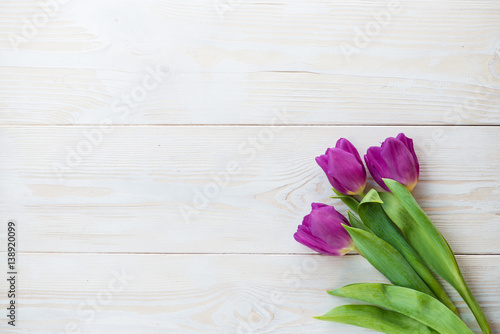 Fototapeta Naklejka Na Ścianę i Meble -  Colorful tulips on wooden table. Top view with copy space