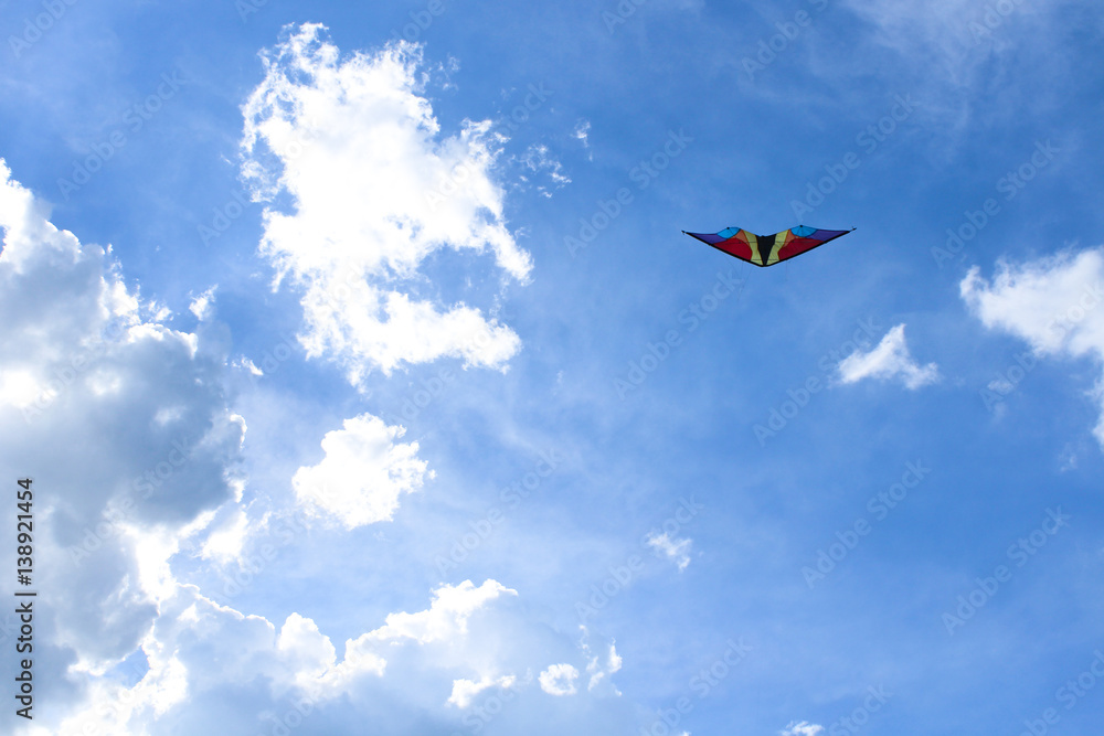 Fototapeta premium Kite on a blue sky background with clouds