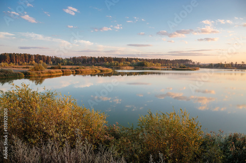 Pond in countryside in autumn at sunset