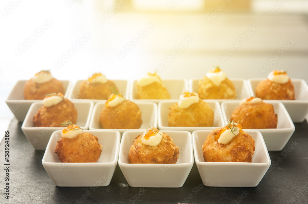 Cheese balls with cream salad in white small bowl with light flare. Cheese balls with cream salad in white small bowl with light flare.