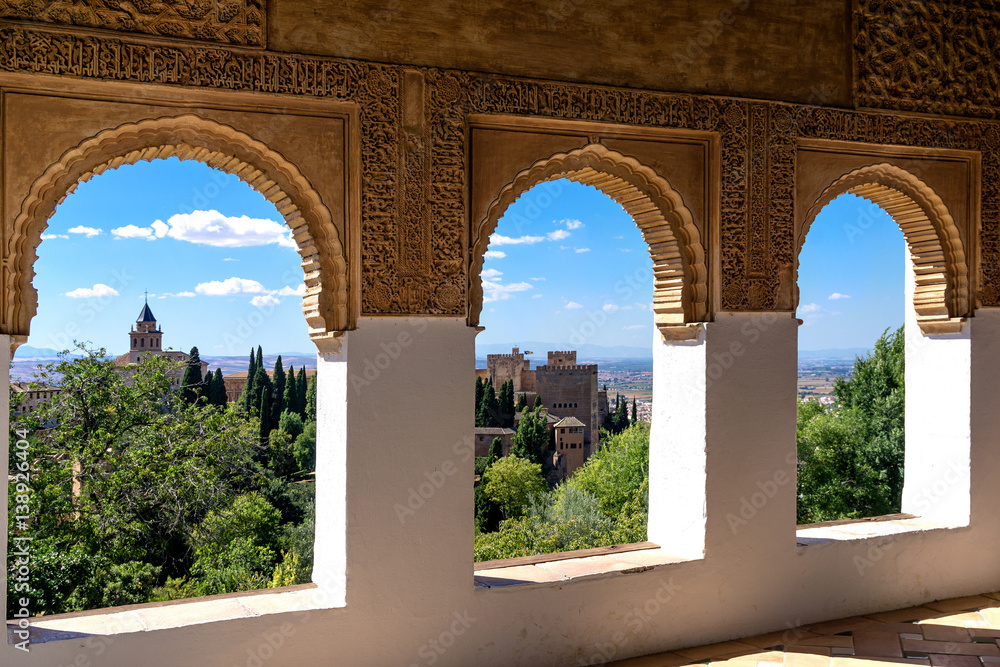 Stone arches in the world-famous Alhambra in Granada with beautiful views of the fortress and Granada.