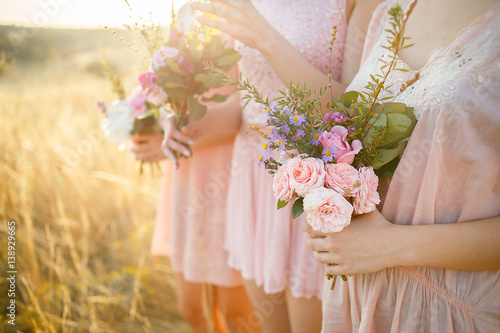bridesmaids in pink dresses with bouquets photo