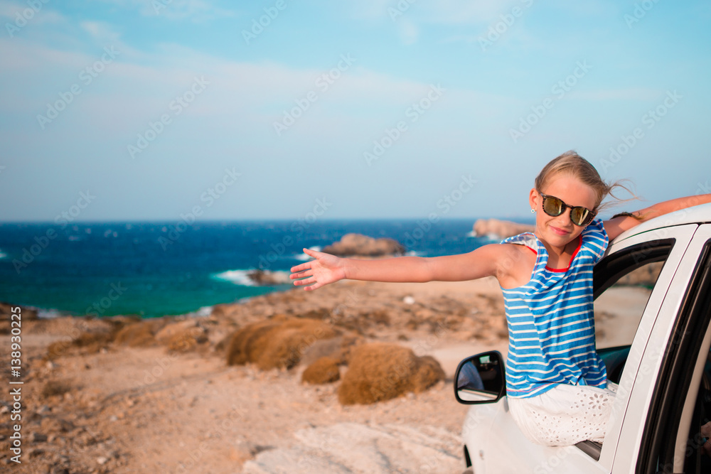 Little girl on vacation travel by car background beautiful landscape