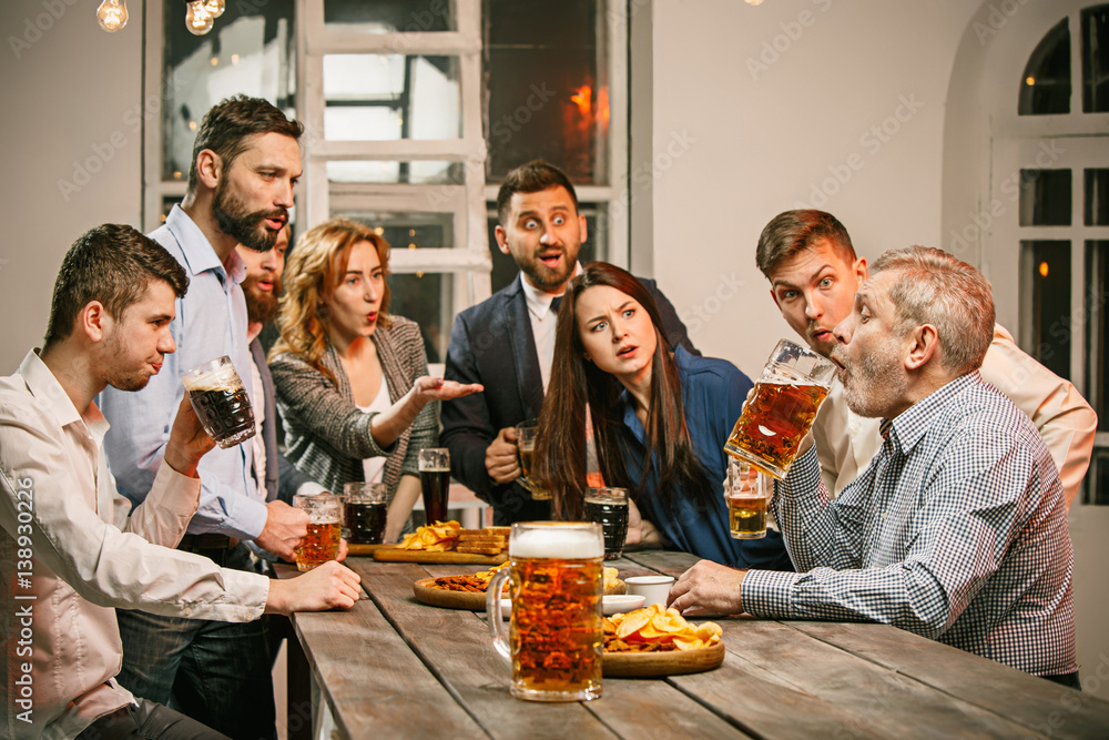 Group of friends enjoying evening drinks with beer Group of friends enjoying evening drinks with beer