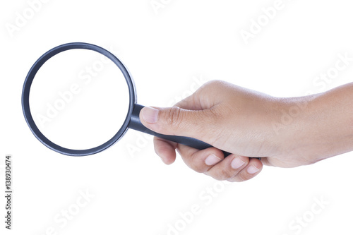 hand holding the magnifying glass on white background