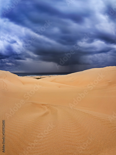 Fototapeta Naklejka Na Ścianę i Meble -  Sand dune dark clouds sea