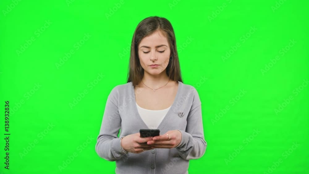 Woman receiving bad news on her phone slow motion on green screen background. Woman receiving bad news on her phone slow motion on green screen background.