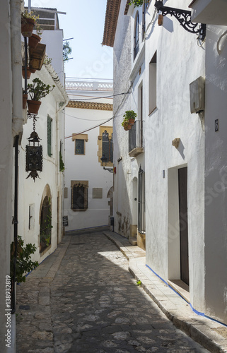 Narrow medieval street in Old Sitges town, Barcelona, Spain © Olivia
