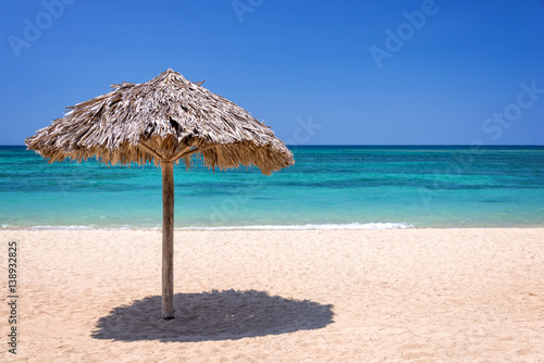 Straw umbrella on a beautiful tropical beach