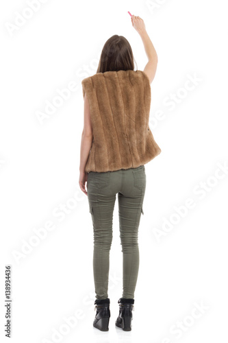 Woman In Brown Fur Waistcoat Writing. RearView