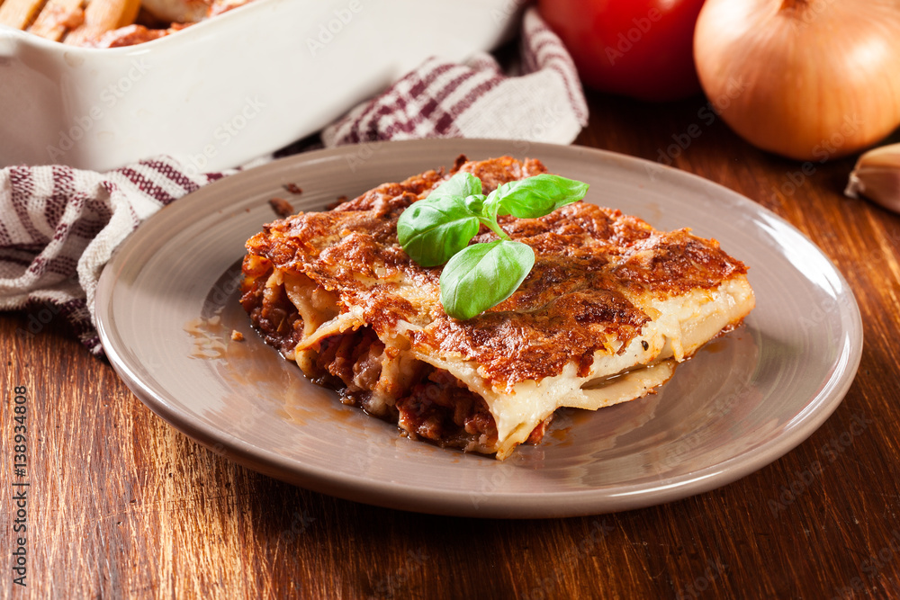 Baked cannelloni with minced meat and bechamel sauce on a plate Baked cannelloni with minced meat and bechamel sauce on a plate