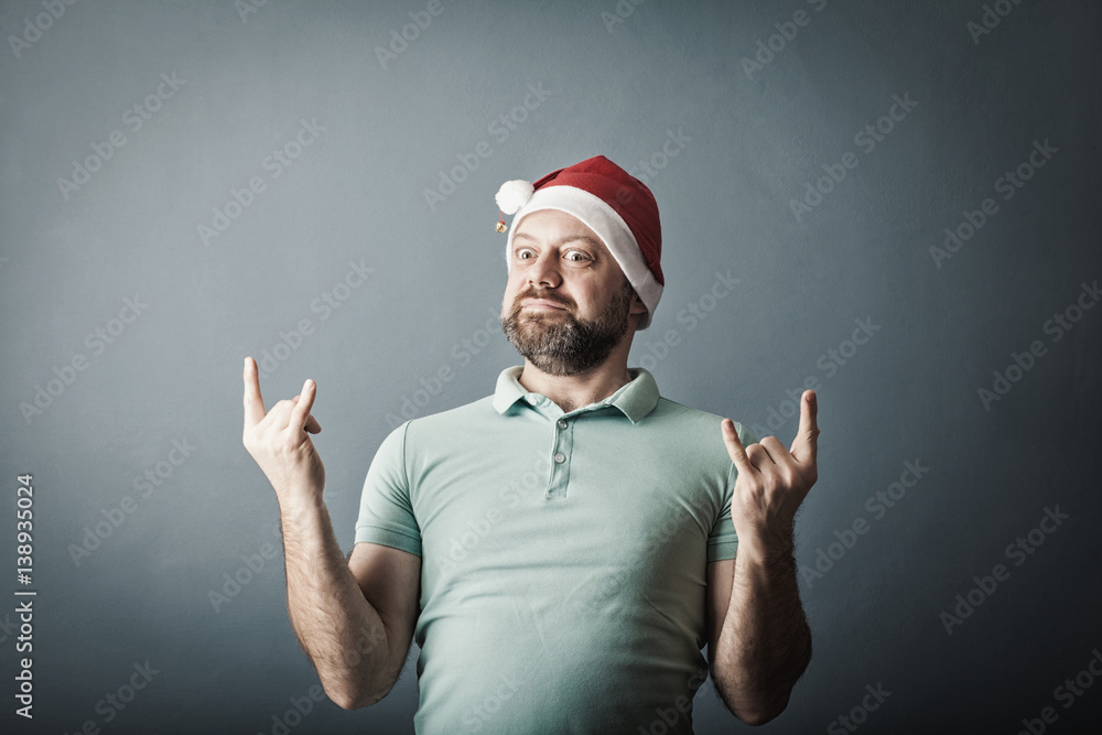 a bearded middle-aged man in a santa hat showing gesture well a bearded middle-aged man in a santa hat showing gesture well