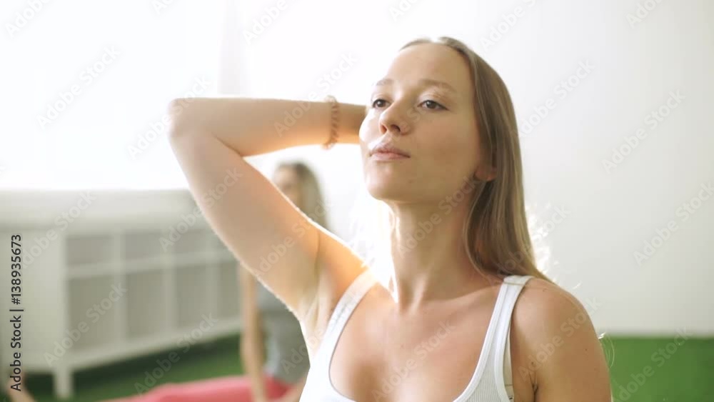 Beautiful woman preparing for yoga class in fitness studio. Portrait of a beautiful, athletic women Beautiful woman preparing for yoga class in fitness studio. Portrait of a beautiful, athletic women