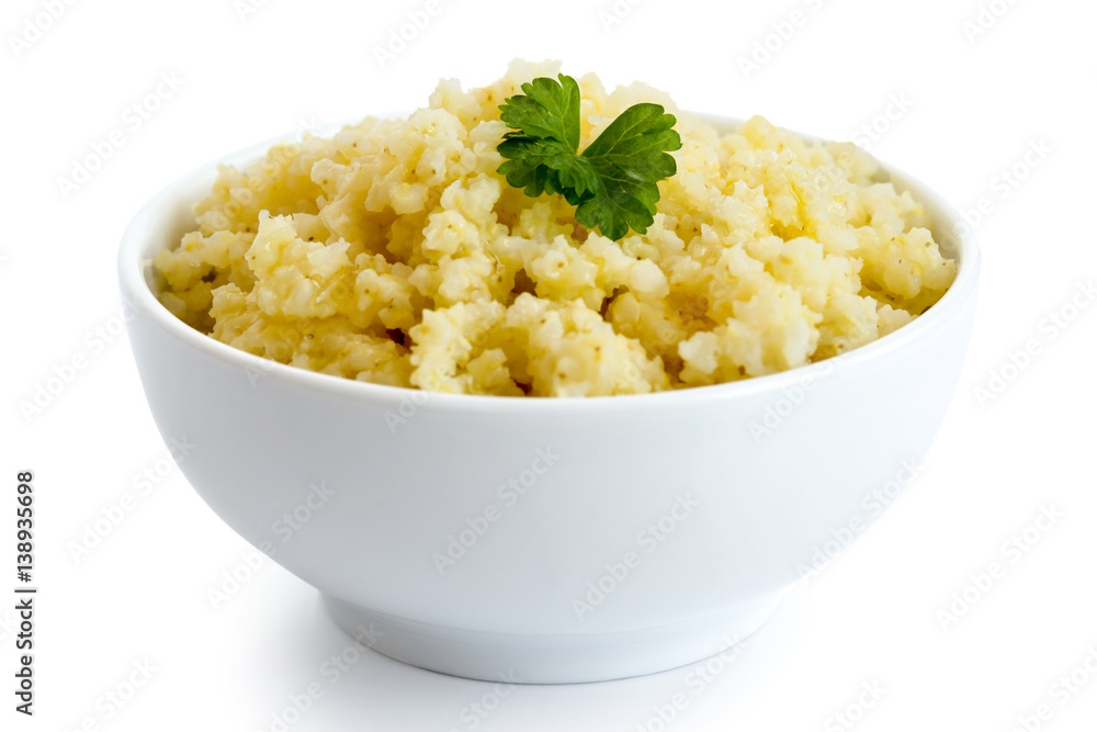 Cooked millet with green parsley in white ceramic bowl isolated on white. Cooked millet with green parsley in white ceramic bowl isolated on white.