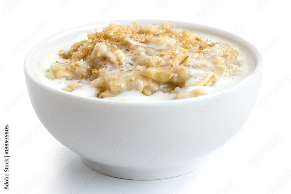 Cooked whole porridge oats with milk and brown sugar in white ceramic bowl isolated on white. Cooked whole porridge oats with milk and brown sugar in white ceramic bowl isolated on white.