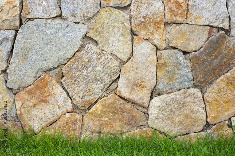 stonework background with green grass stonework background with green grass
