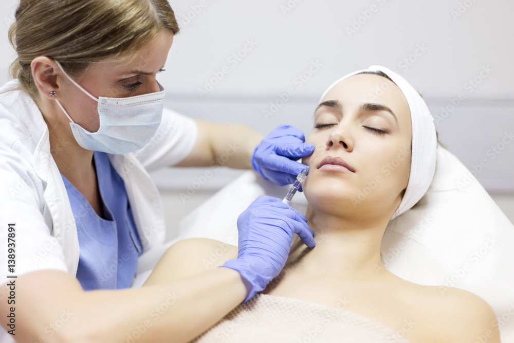 Woman receiving Botox injection Woman receiving Botox injection