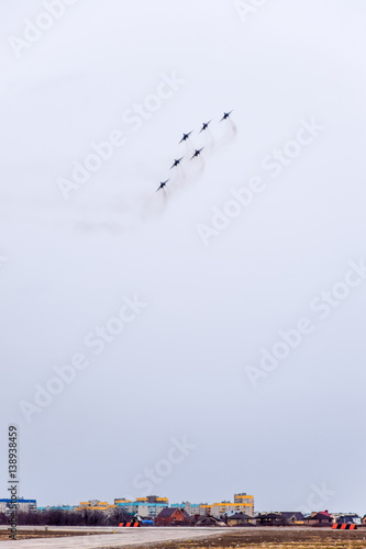 Air show in the sky above the Krasnodar airport flight school. Airshow in honor of Defender of the Fatherland. MiG-29 in the sky. photo