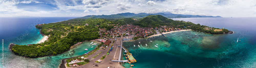 Aerial panorama of the tropical lagoon and marine port in the town of Padang Bai, Bali, Indonesia