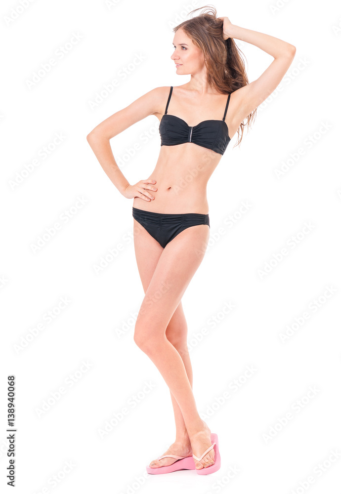 Sexy young woman posing in a black bikini, isolated on white background Sexy young woman posing in a black bikini, isolated on white background