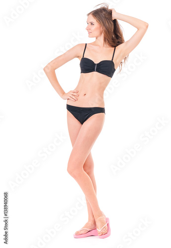 Sexy young woman posing in a black bikini, isolated on white background 