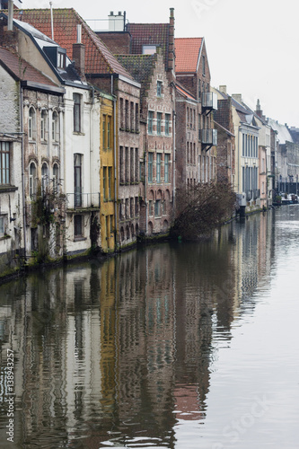 View of canals and streets of Gent town, Belgium in rainy day in winter