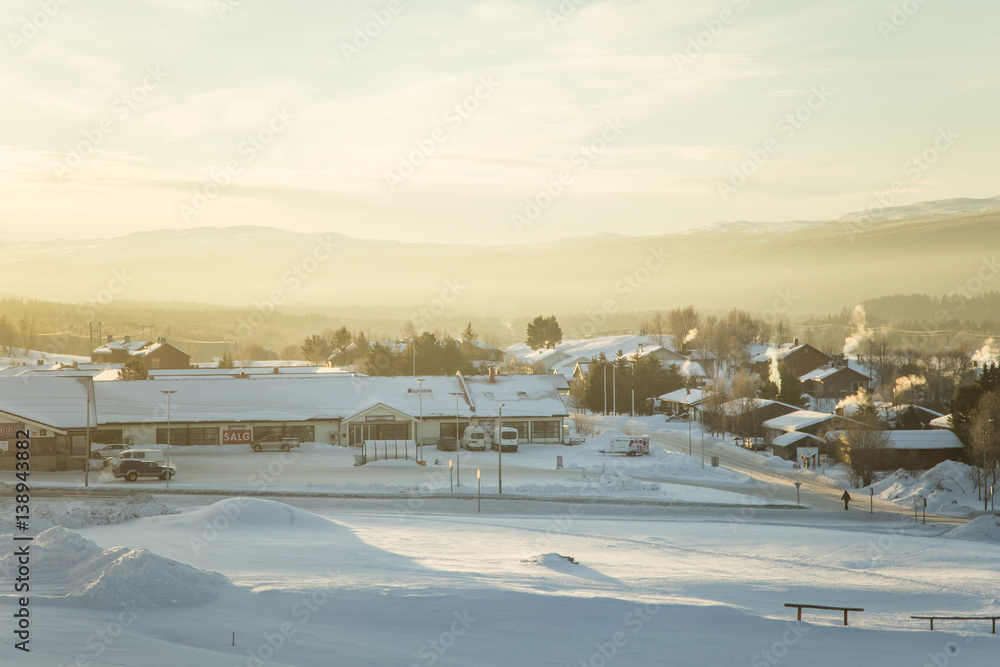 A beautiful morning panorama of a small Norwegian town during sunrise with a flares and warm look