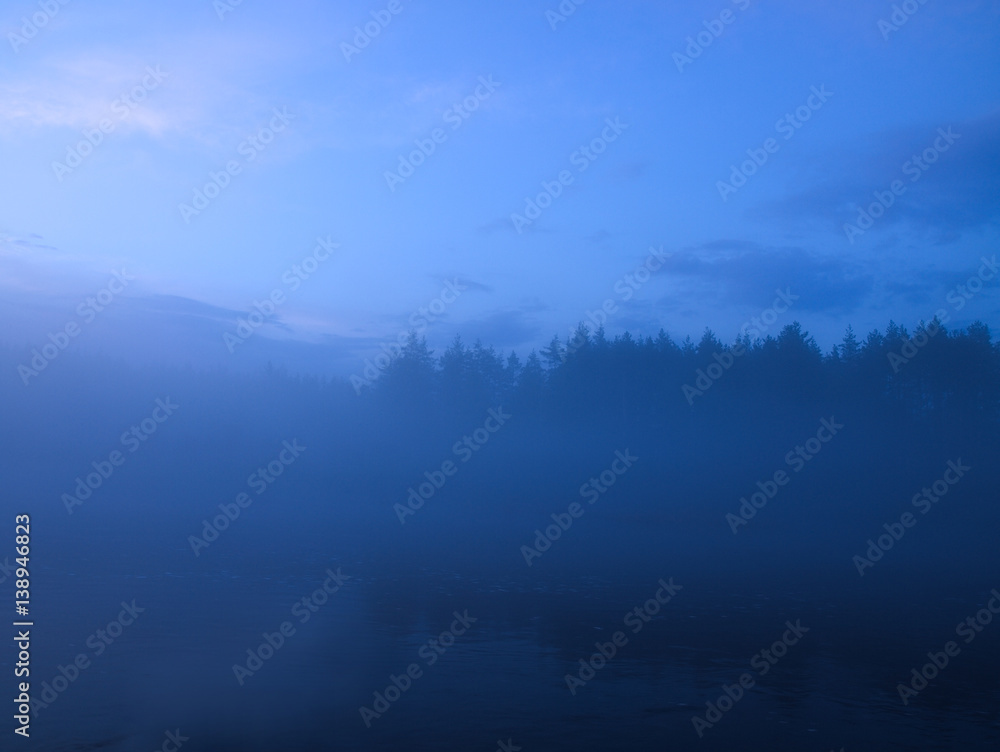 the background is mist over the river after sunset