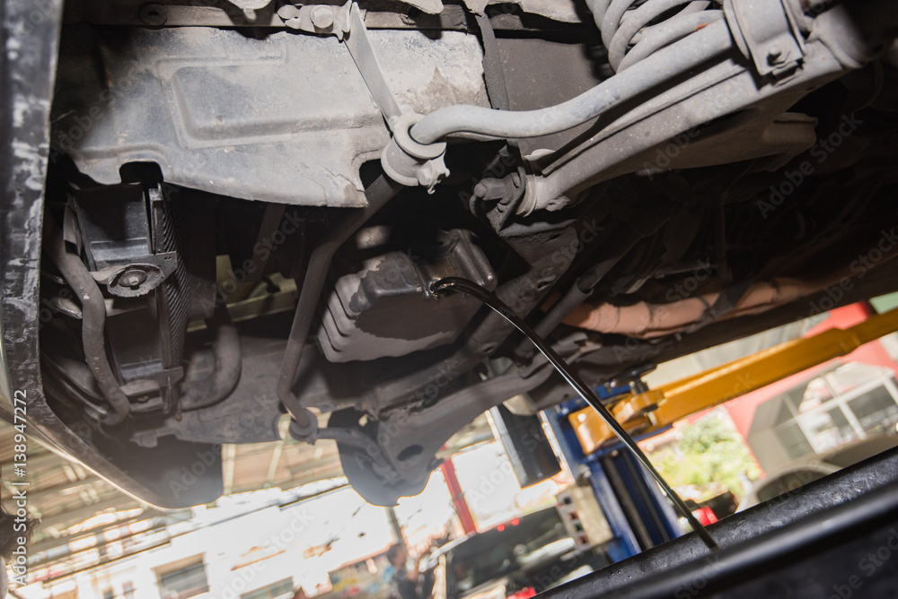 Obraz premium oil change, pouring oil to car engine