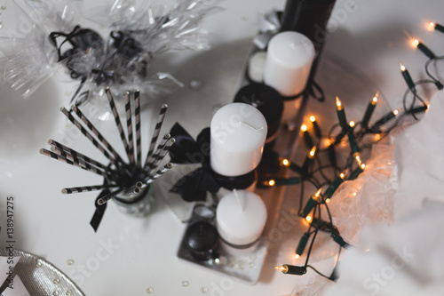 Holiday table setting with white candles and bulb garland
