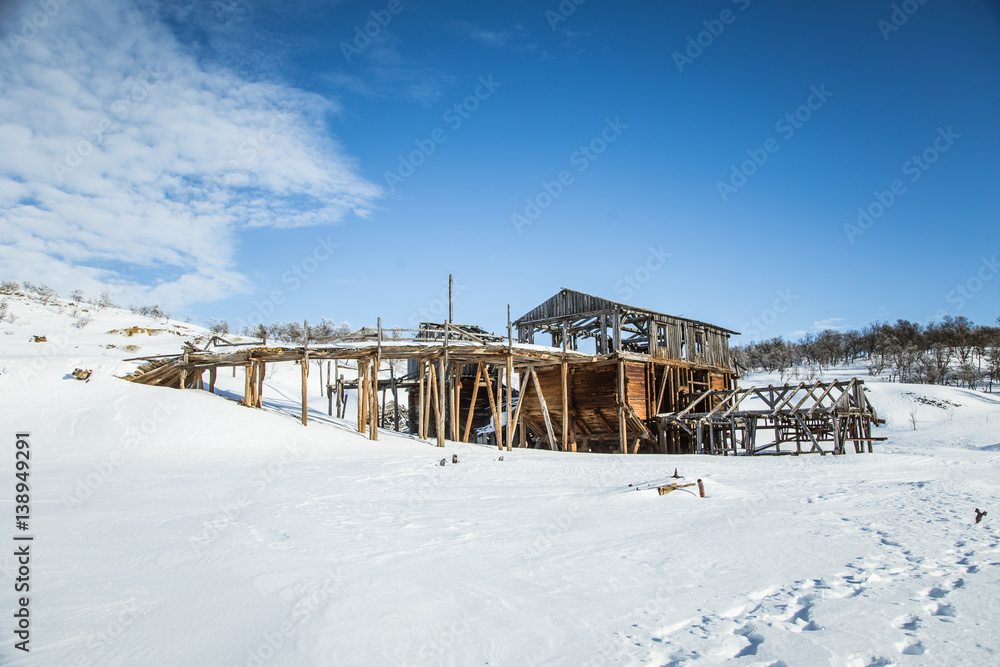 An old, abandoned copper mine building in the snowy Norway landscape An old, abandoned copper mine building in the snowy Norway landscape